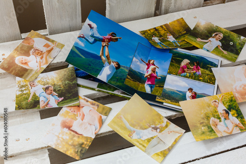 Family photos archive saved in brightly designed photo book; bright summer memories placed in the photobook.