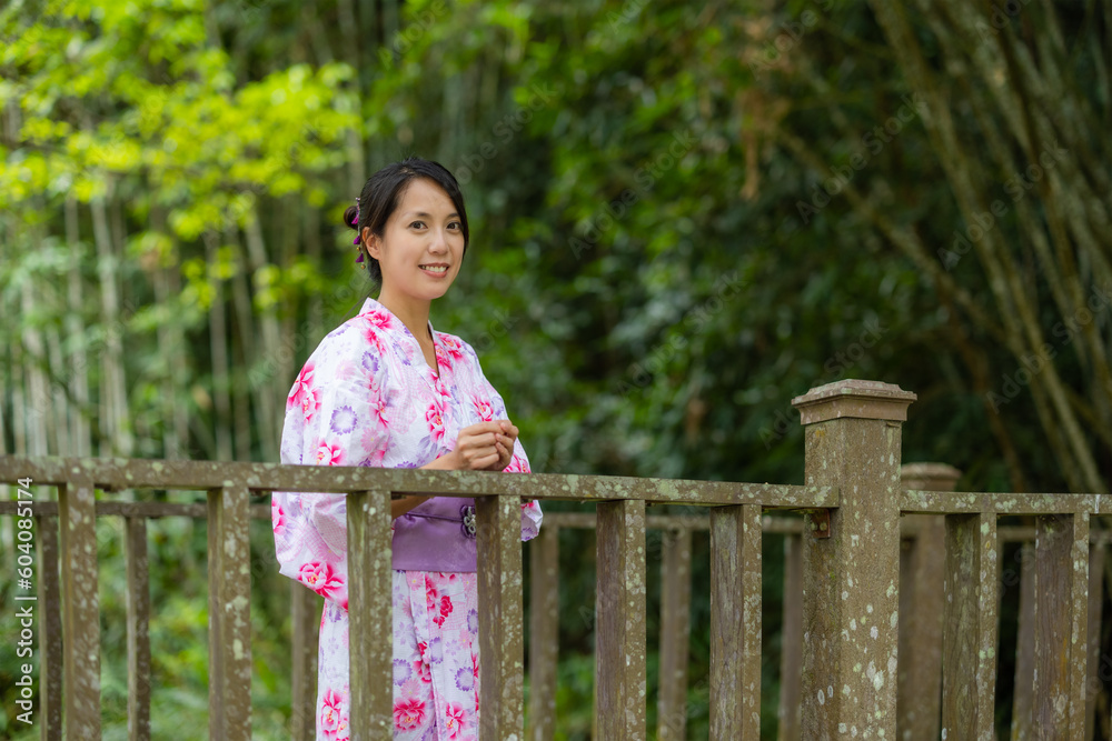 Woman wear kimono over the green background