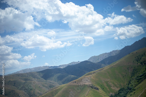 Fototapeta Naklejka Na Ścianę i Meble -  Cumulus clouds over mountain peaks