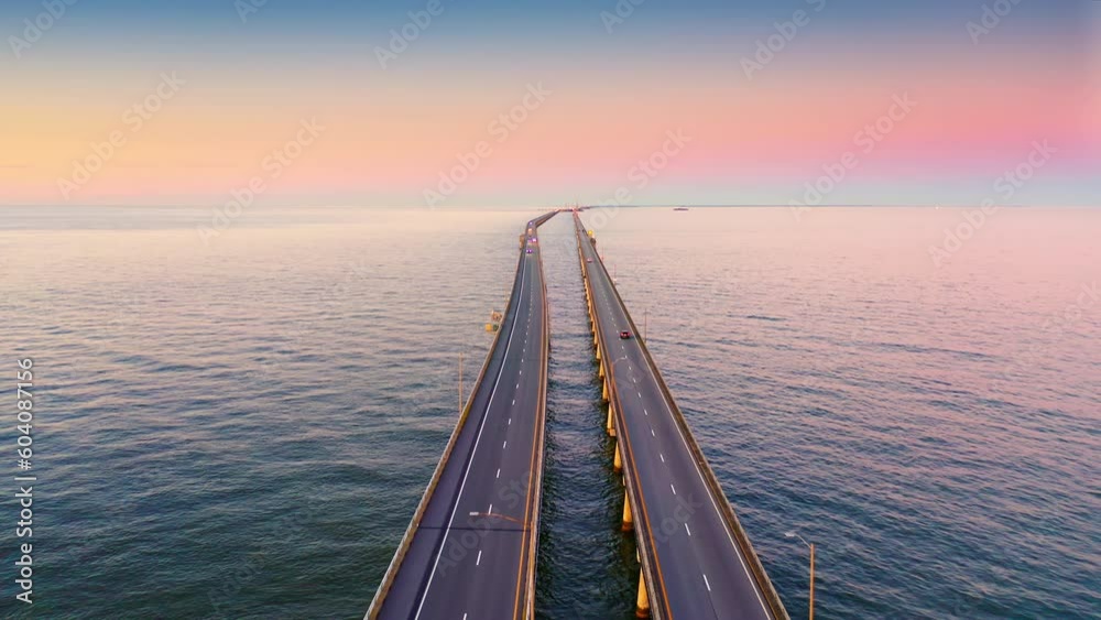 Aerial view of Chesapeake Bay Bridge Tunnel at sunset with backward camera motion. CBBT is a 17.6-mile bridge tunnel that crosses the mouth of the Chesapeake Bay.