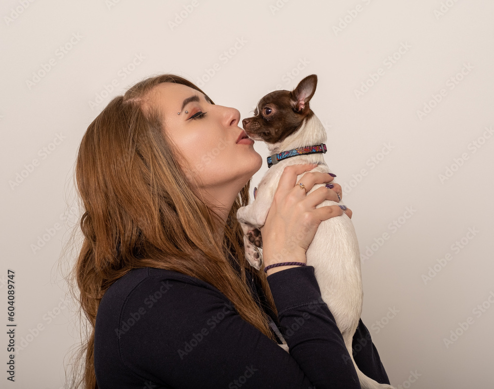 Girl kissing a chihuahua dog