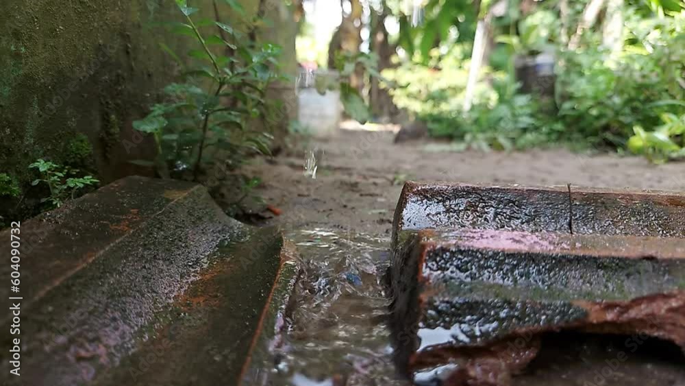 Natural and clear water flowing near stone and bricks in the garden. slow motion footage Natural and clear water flowing near stone and bricks in the garden. slow motion footage