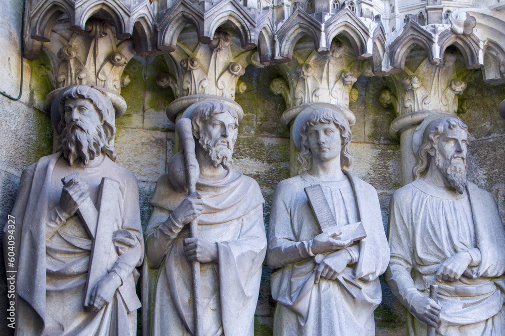 Sculptural images of the Holy Apostles on the wall of the facade of Saint Fin Barre's Cathedral in Cork, Ireland. The Apostles Andrew, James major, Thomas, Matthias.
