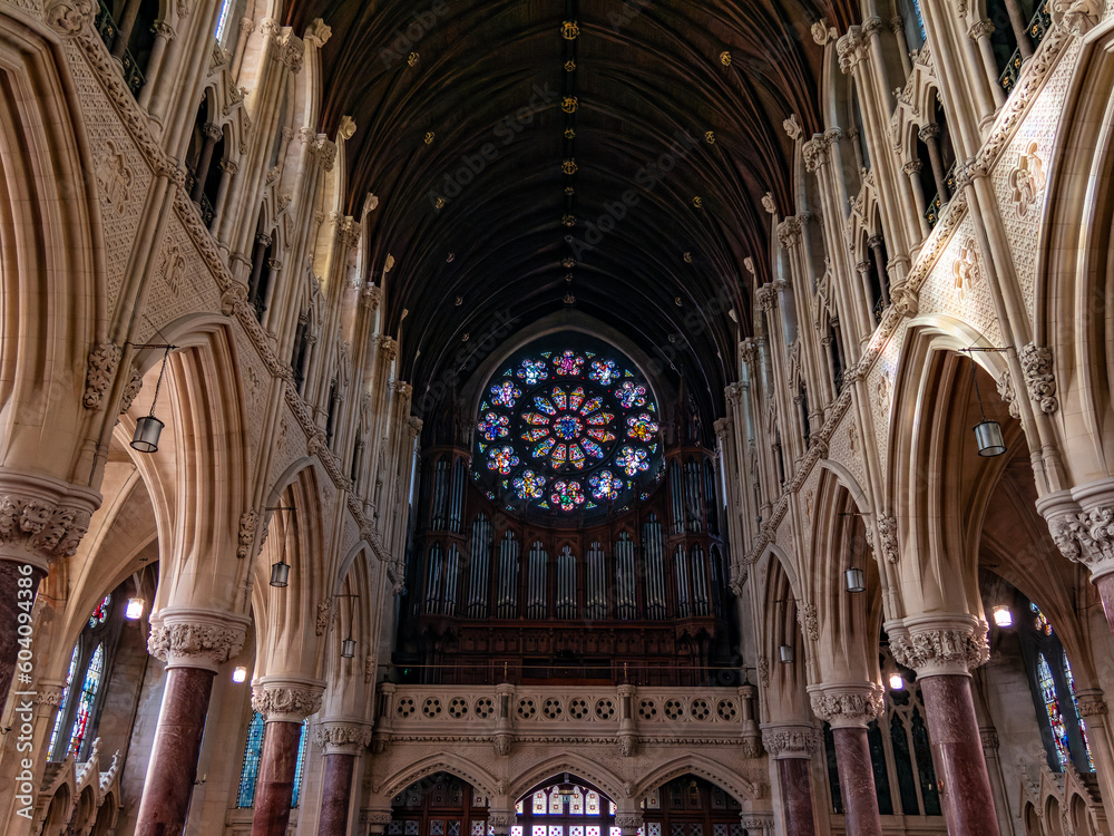 A large multicolored stained glass window in the Roman Catholic Church of the city of Cobh. The interior of Cathedral Church of St Colman.