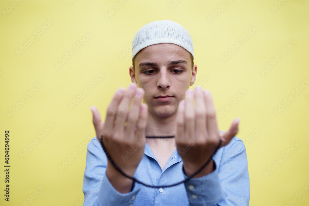 young muslim man praying, concept of peace, harmony and happy life filled with belief in God young muslim man praying, concept of peace, harmony and happy life filled with belief in God