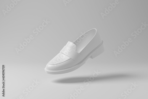 White chunky loafer floating in mid air with shadow on white background in monochrome. Illustration of the concept of footwear, menswear and fashion photo