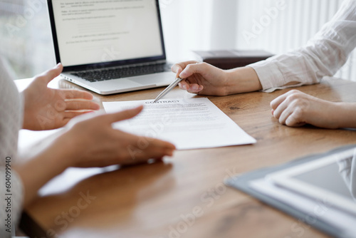 Business people discussing contract signing deal while sitting at the wooden table in office. Partners or lawyers working together at meeting. Teamwork  partnership  success concept.