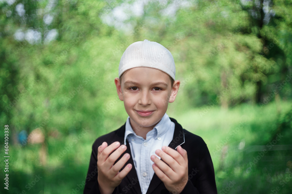 young muslim boy praying, concept of peace, harmony and happy life filled with belief in God young muslim boy praying, concept of peace, harmony and happy life filled with belief in God