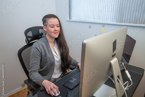 Woman working from home in her ergonomic office.