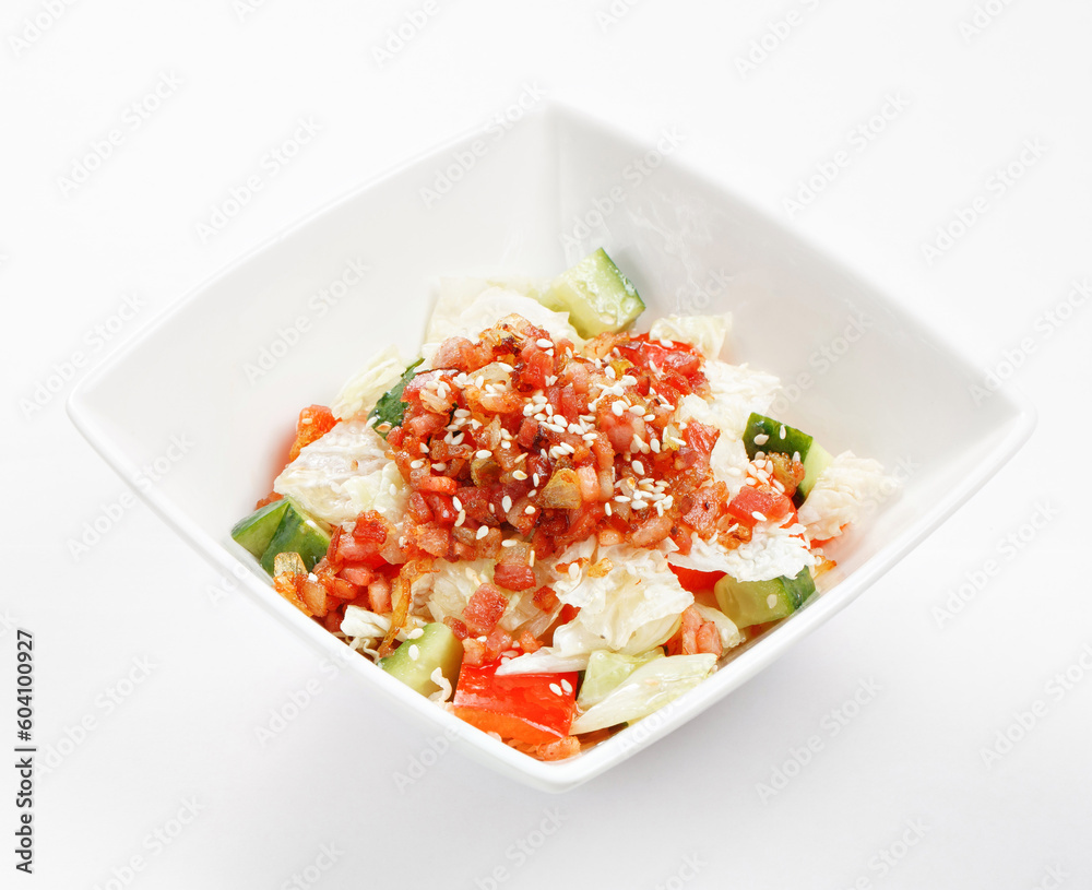 mixed vegetable salad with bacon, tomatoes, onions and feta cheese in a white bowl on white background mixed vegetable salad with bacon, tomatoes, onions and feta cheese in a white bowl on white background