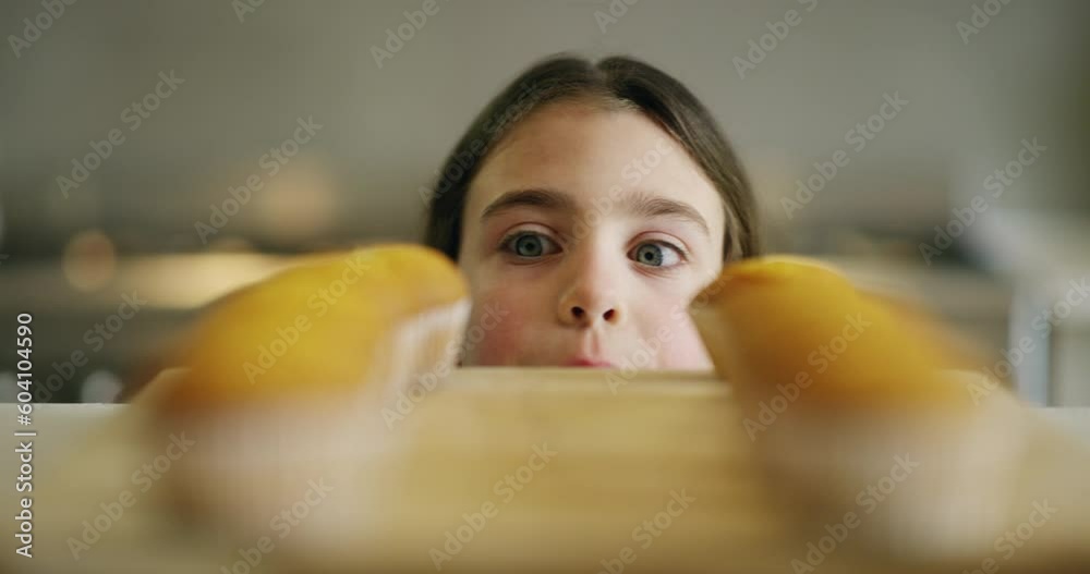 Girl, kitchen and kid stealing food, dessert or baked cupcake on counter and hungry for sugar. Naughty, child and cheat on diet, nutrition and secret eating of sweet homemade muffin on table