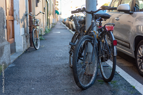 Bicycles Attached to a Light Pole in the Street in Italy