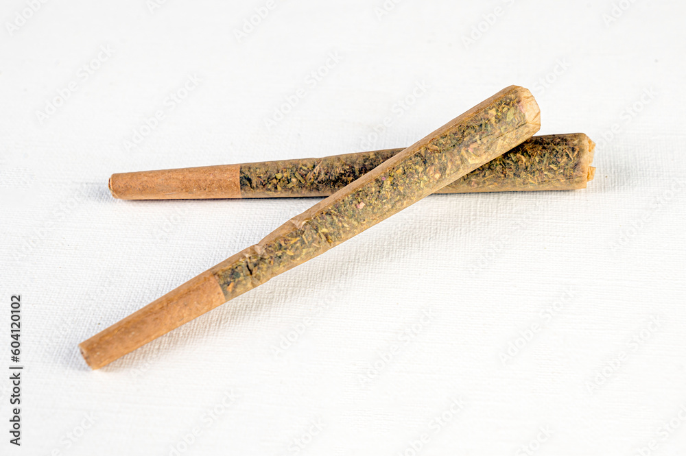 Marijuana joint pre-rolled cone paper on white background, roll paper cannabis - obrazy, fototapety, plakaty 