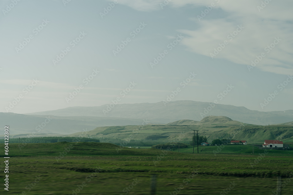 Scenic view of green landscape against sky at Iceland Scenic view of green landscape against sky at Iceland