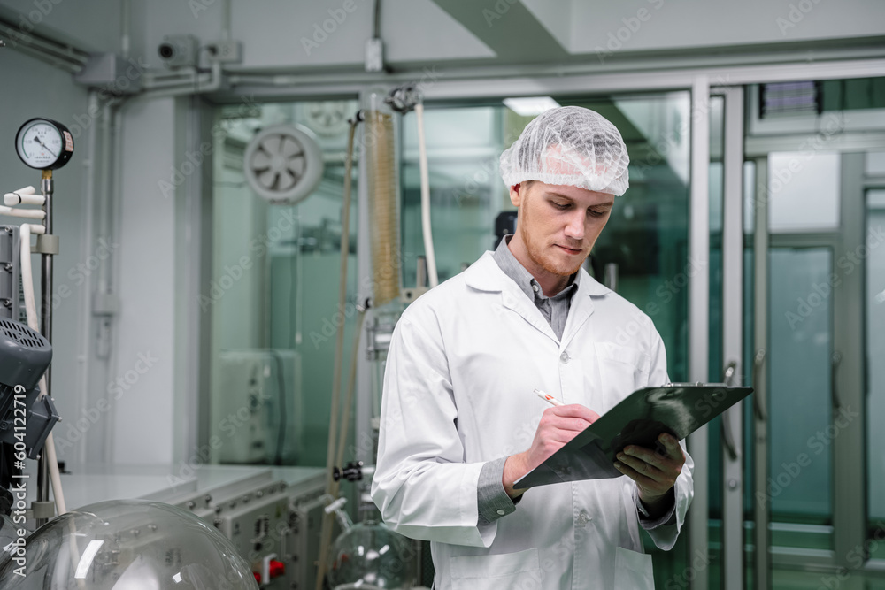 A researcher is investigating quality and analyzing cannabis plants. Herbal alternative for medicine. Scientist extracting cannabis oil in a laboratory. A researcher is investigating quality and analyzing cannabis plants. Herbal alternative for medicine. Scientist extracting cannabis oil in a laboratory.