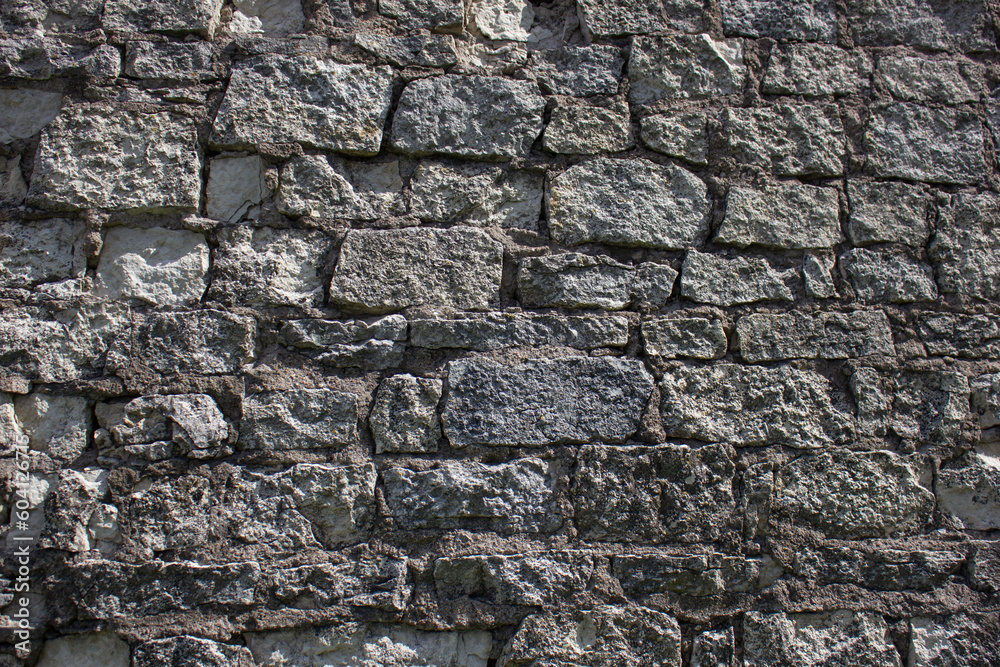 Ancient wall of dark color from destroyed stones. Background, texture of ancient stones, blocks.Ancient wall. Ancient wall of dark color from destroyed stones. Background, texture of ancient stones, blocks.Ancient wall.