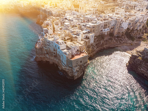 Fotografie Aerial view of Polignano a Mare, a village built on the edge of the sandstone cliffs above the Adriatic Sea in Apulia, Italy