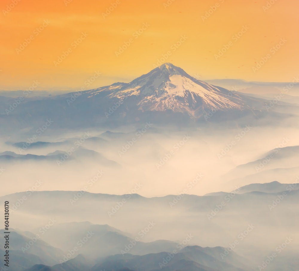 An aerial shot of Mt Hood with fog laying in the valleys surrounding the mountain, near Portland, Oregon.