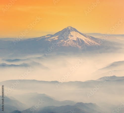 An aerial shot of Mt Hood with fog laying in the valleys surrounding the mountain, near Portland, Oregon.