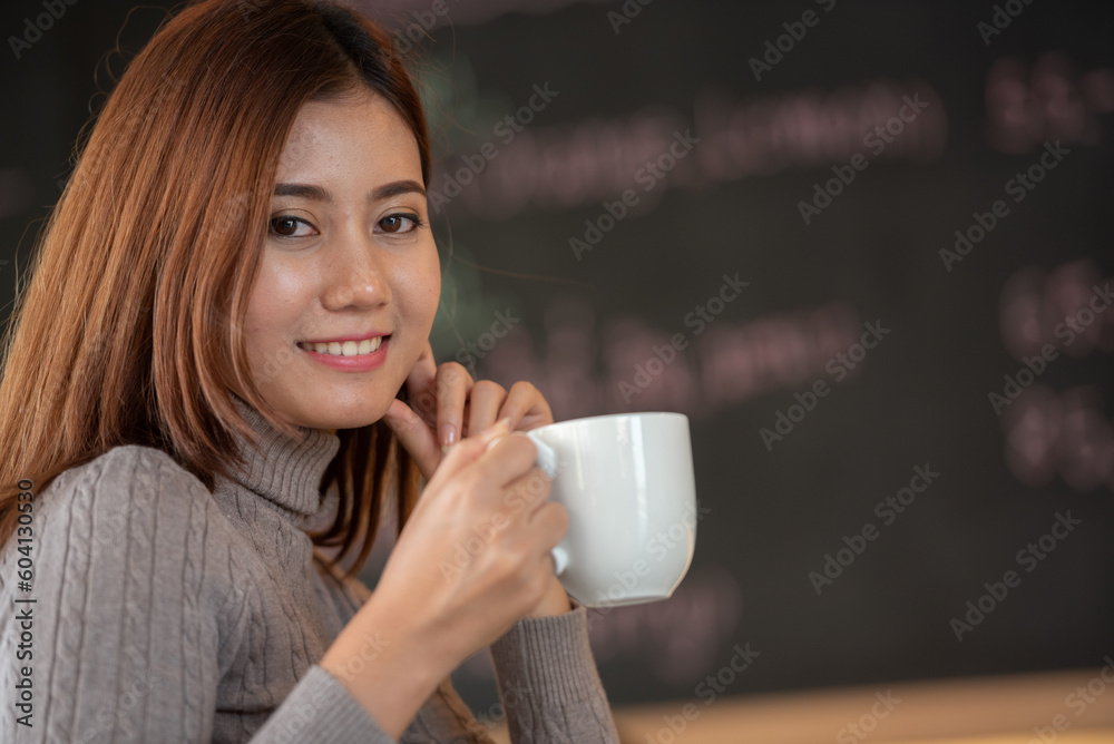 Banner of Asian woman Proprietor holding hot coffee in white ceramic cup to sniff smell of espresso in office work place . business owner entrepreneur girl carry coffee break to sniff fragrant smell Banner of Asian woman Proprietor holding hot coffee in white ceramic cup to sniff smell of espresso in office work place . business owner entrepreneur girl carry coffee break to sniff fragrant smell