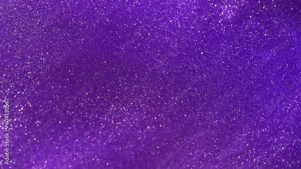 The Hypnotic Waves of White Dust Particles in Purple Liquid. Violet Visions. A Fantastic Show of White Stardust Particles Flowing in Purple Fluid. The Hypnotic Waves of White Dust Particles in Purple Liquid. Violet Visions. A Fantastic Show of White Stardust Particles Flowing in Purple Fluid.