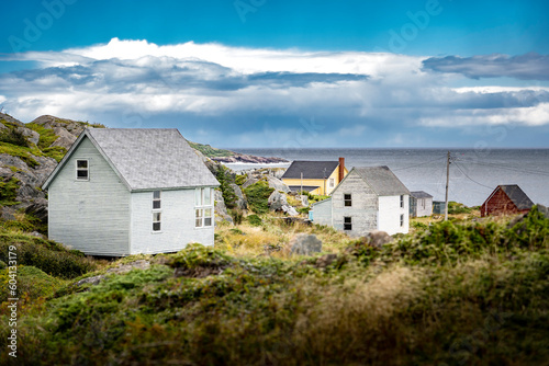 East Coast homes on a rocky shoreline overlooking the Atlantic Ocean at Keels Newfoundland Canada. © Ramon Cliff