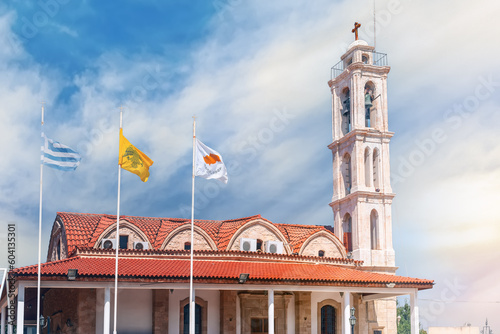 KOLOSSI, CYPRUS- JUNE 15, 2018: The church of Apostolos Lukas with flags of Cyprus, the Greek Orthodox church and Greece in front of it. Kolossi village. Limassol District. Cyprus photo