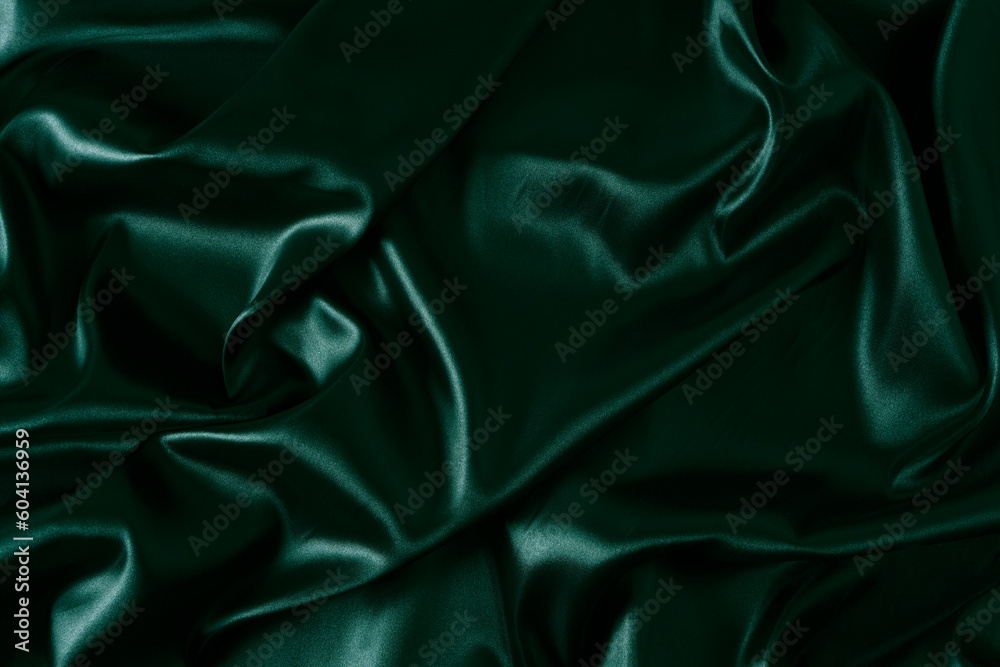 Obraz premium Silk fabric, abstract wavy green satin fabric background.