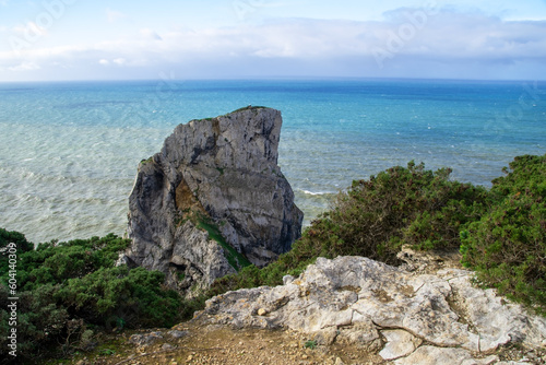 Panorama of the ocean coast and rock bay, Atlantic Ocean, beautiful cloudscape, dramatic landscape, colorful seascape with sheer rocks, travel content, Lisbon, Portugal