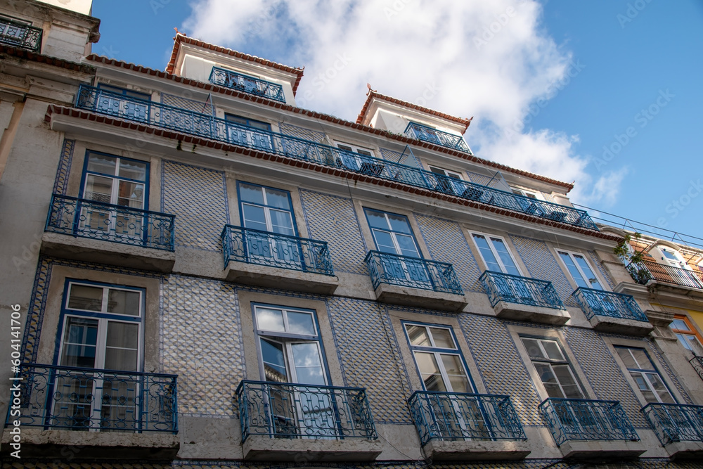 Facade of an old house with windows, European historical buildings, Lisbon, Portugal