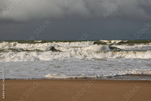 Empty wild sandy beach, Atlantic Ocean seascape, sea waves, beautiful cloudscape, dramatic landscape, travel content, Lisbon, Portugal © Elena