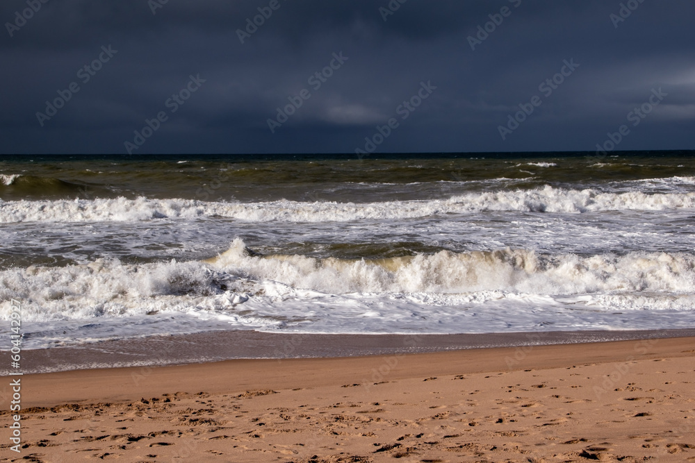 Empty wild sandy beach, Atlantic Ocean seascape, sea waves, beautiful cloudscape, dramatic landscape, travel content, Lisbon, Portugal Empty wild sandy beach, Atlantic Ocean seascape, sea waves, beautiful cloudscape, dramatic landscape, travel content, Lisbon, Portugal