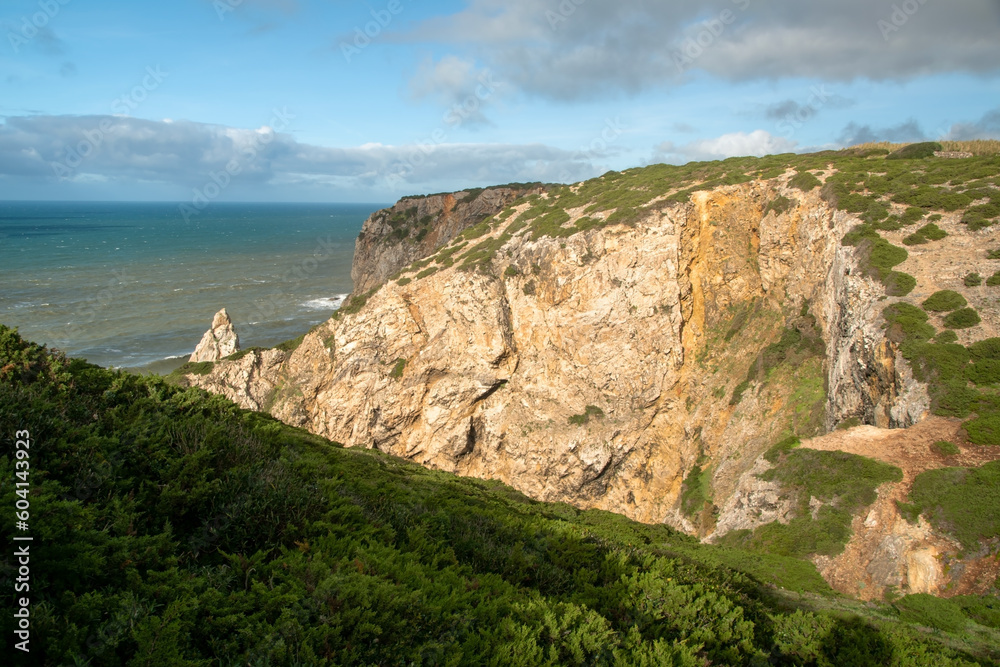 Panorama of the ocean coast and rock bay, Atlantic Ocean, beautiful cloudscape, dramatic landscape, colorful seascape with sheer rocks, travel content, Lisbon, Portugal