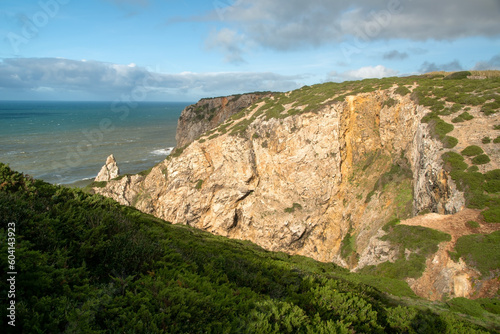 Panorama of the ocean coast and rock bay, Atlantic Ocean, beautiful cloudscape, dramatic landscape, colorful seascape with sheer rocks, travel content, Lisbon, Portugal