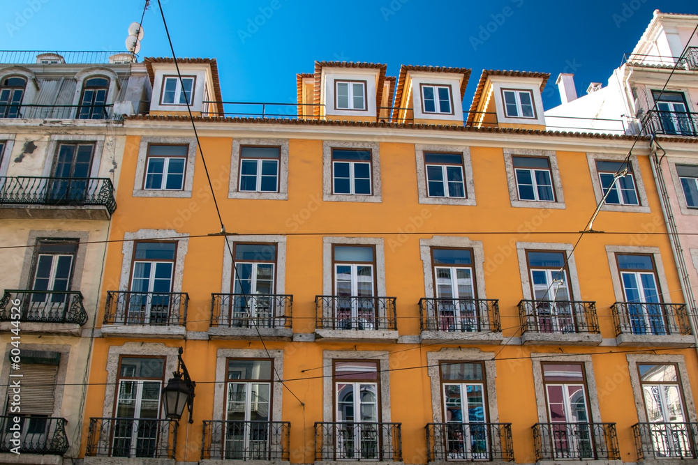 Facade of an old house with windows, European historical buildings, cozy cityscape, Portuguese streets landscape, view of city 