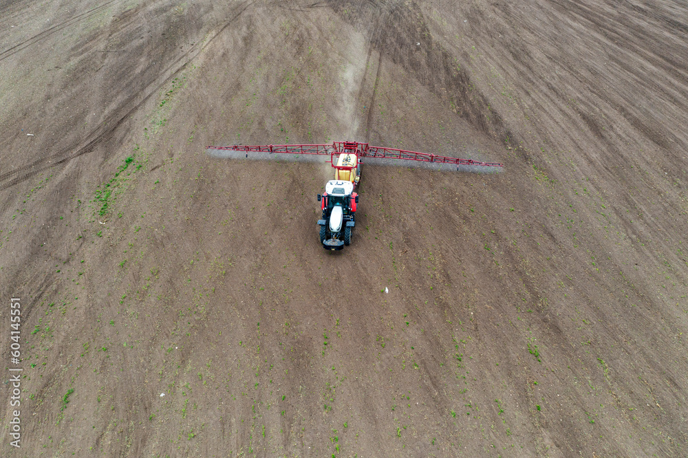Top view of tractor spraying grain on a field.