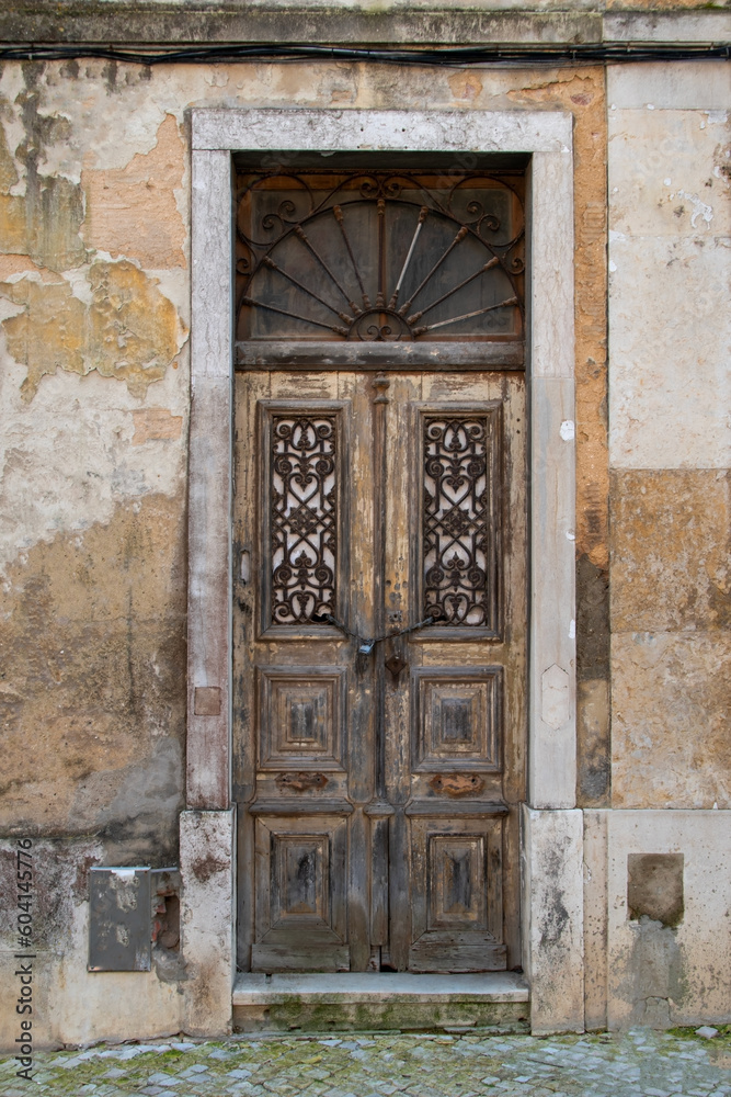 Facade of an old house with vintage door, European historical buildings, Lisbon, Portugal