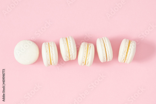Vanilla french desserts. Cake macaroons or macaroon on pink background, white almond cookies, pastel colors, macaroon for sweet break mock up