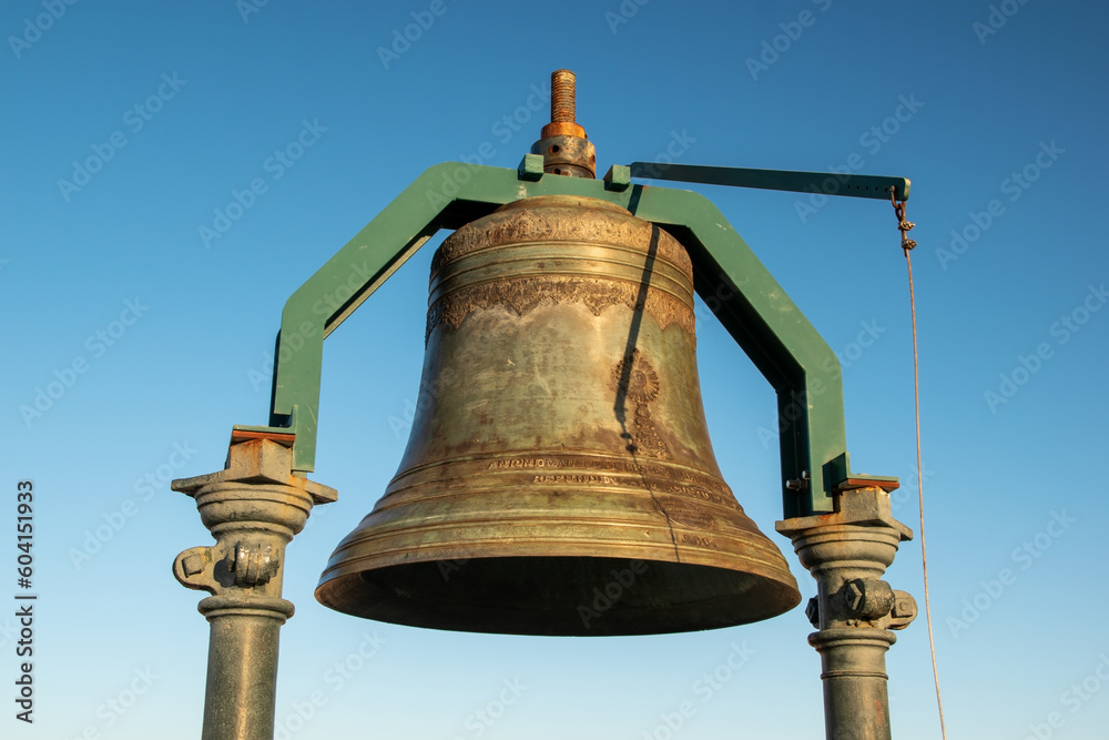 Fototapeta premium Big old bronze bell against the blue sky
