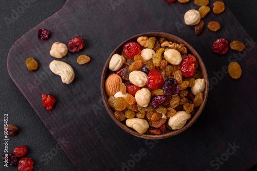 Mix of roasted cashews, hazelnuts and walnuts with dried cranberries and raisins © chernikovatv