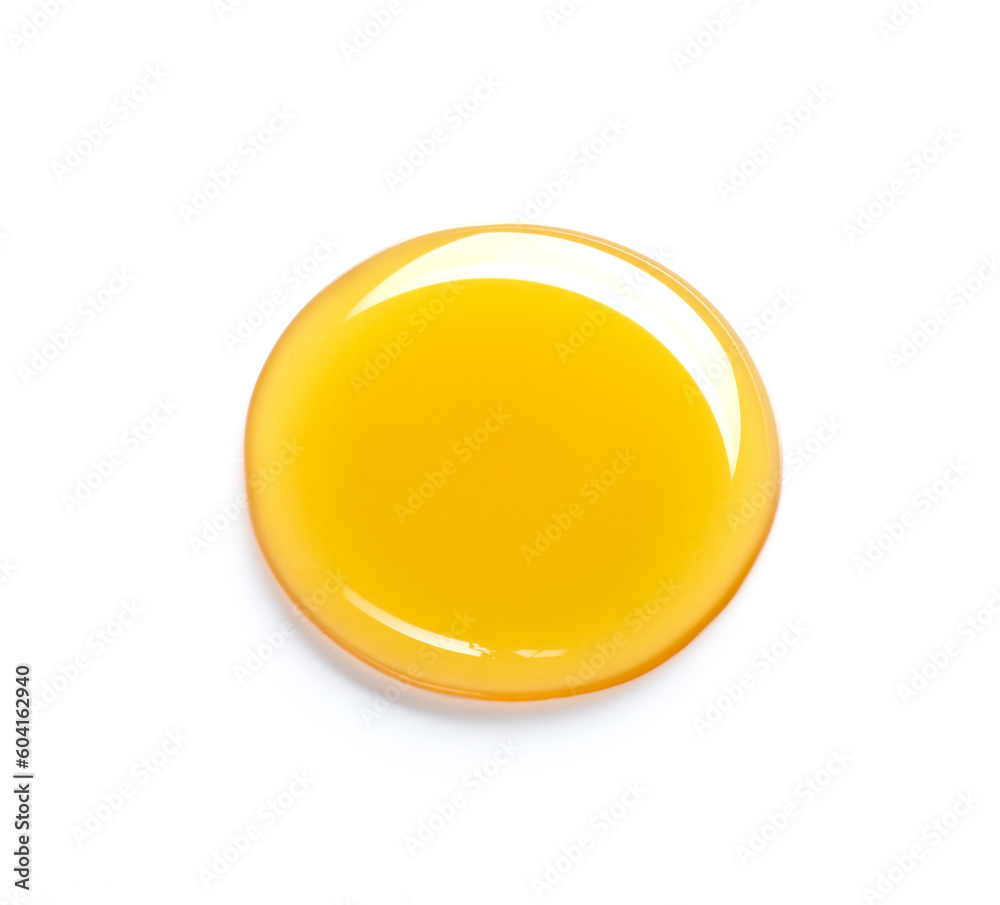 Beautiful drop of honey or other yellow liquid isolated on white background. Yellow or orange drop of oil on a light background
