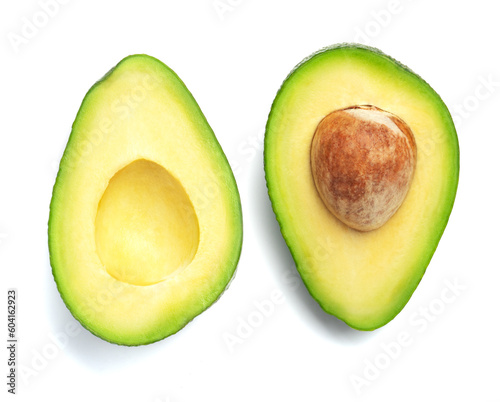 Beautiful two halves of a fresh perfect avocado isolated on a white background. Avocado with pit top view on a light background
