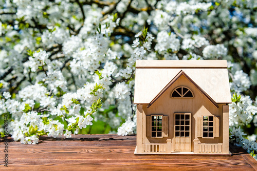 The symbol of the house stands against a background of cherry blossoms 