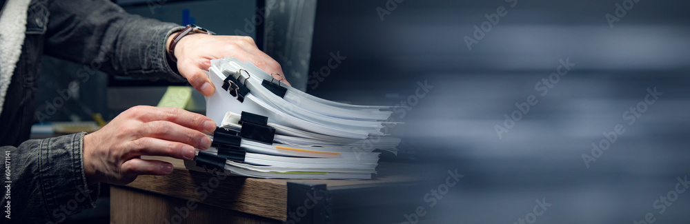 Businessman hands working in stacks documents
