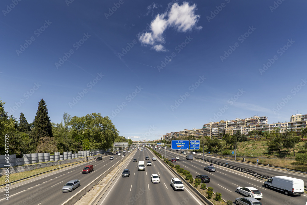 Road traffic in the lanes of the highway in the ring road of Madrid