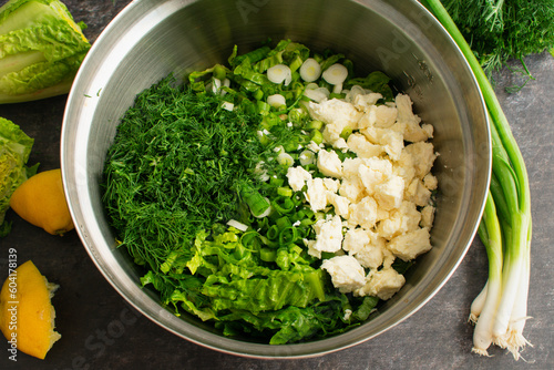 Maroulosalata Greek Lettuce Salad Ingredients in a Mixing Bowl: Hearts of romaine, dill, scallions, and feta cheese before being mixed photo