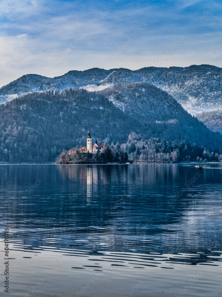 Assumption of Maria Church island in the middle of lake bled and snow the mountain during winter, Slovenia