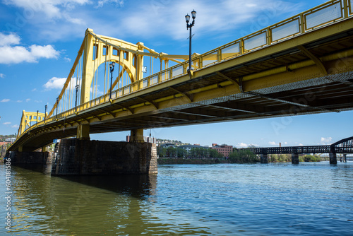 Rachel Carson bridge crossing Allegheny River in Pittsburgh, Pennsylvania, with raildroad bridge in the background.