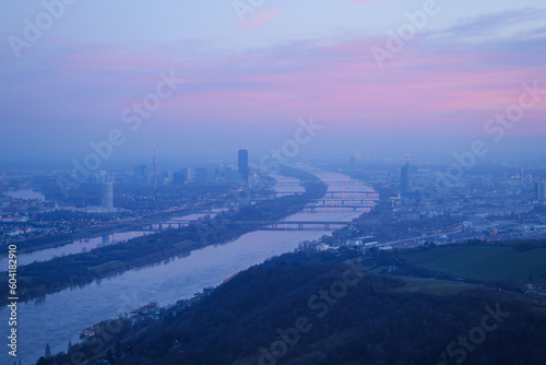 View from Leopoldsberg towards Vienna Danube Skyline with Pink Cloudy Sky at Dusk