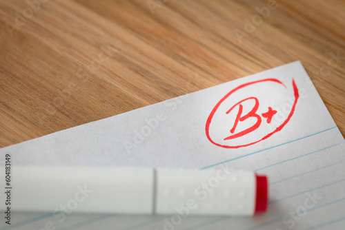 Good grade of B plus (B+) is written with red pen on the test.